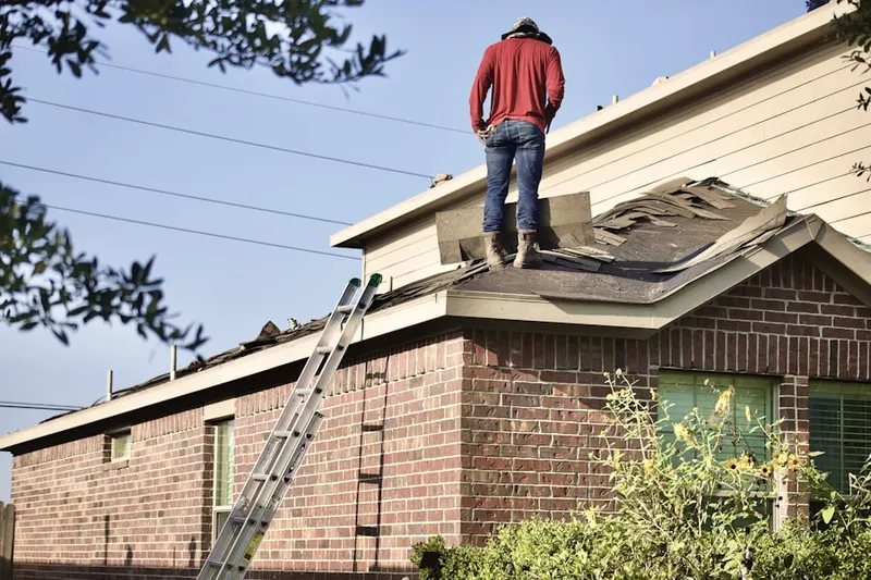 Professional roofer working on a residential roof in Crossons